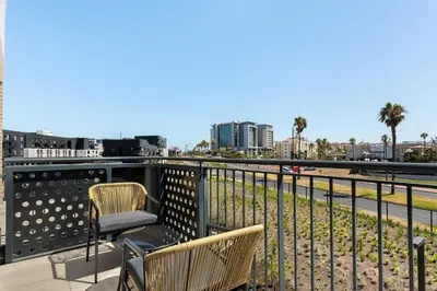 a balcony with two chairs and a view of a city at On Park Apartments in Cape Town