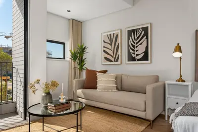 a living room with a couch and a glass table at On Park Apartments in Cape Town