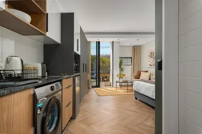 a kitchen with a washer and dryer in a room at On Park Apartments in Cape Town
