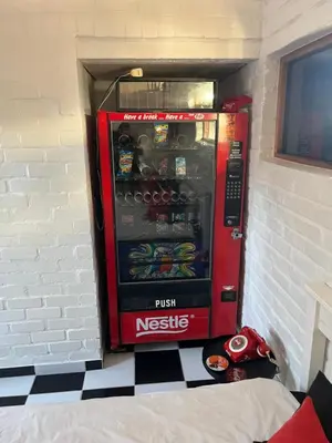 a coca cola vending machine sitting in a wall at The Cola Cabana in Cape Town