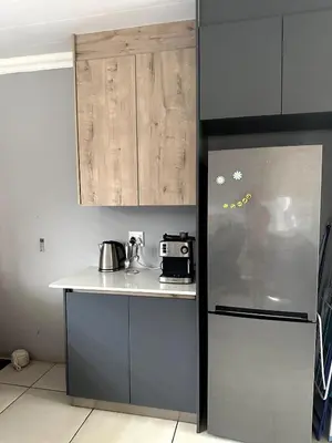 a kitchen with a refrigerator and a counter top at Laid-Back Tortoise in Fisherhaven