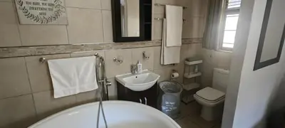 a bathroom with a sink and a toilet at Franschoek - Holiday House on the River in Hou Moed