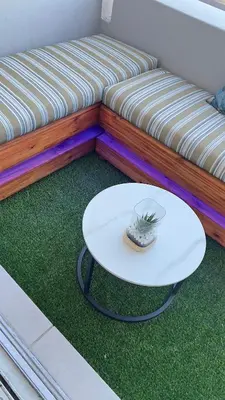 a white coffee table in front of a couch at 2 bed Luxury apartment living in Cape Town
