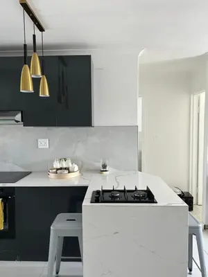 a kitchen with a stove and a white counter top at 2 bed Luxury apartment living in Cape Town