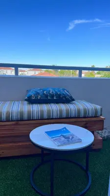 a coffee table in front of a couch with a table at 2 bed Luxury apartment living in Cape Town