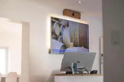 a laptop on a table in a room with a picture on the wall at theLAB Franschhoek in Franschhoek