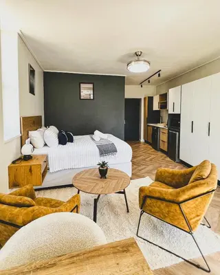 a hotel room with a bed and a table and chairs at Grace On Park by Dajosha in Cape Town