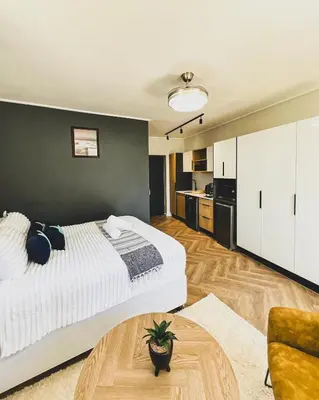 a bedroom with a large bed and a green wall at Grace On Park by Dajosha in Cape Town