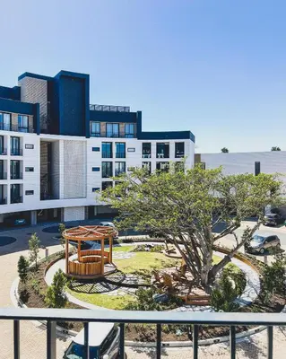 a park with a picnic table in front of a building at Grace On Park by Dajosha in Cape Town