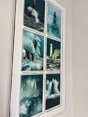 a framed picture of a window with a lighthouse at Hephzibah Inn Signature Farm Cottage in Hermon