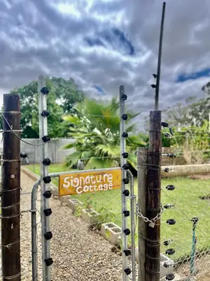 a sign that is attached to a fence at Hephzibah Inn Signature Farm Cottage in Hermon