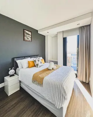 a bedroom with a large bed and a large window at Shalom on Matrix by Dajosha in Cape Town