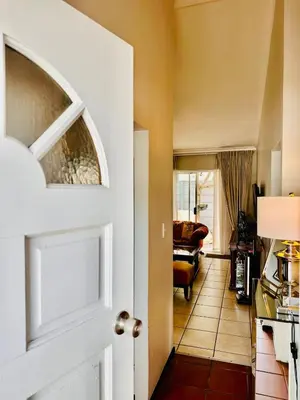an open door to a living room with a couch at Dolce in Cape Town