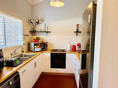 a kitchen with a sink and a stove top oven at Dolce in Cape Town