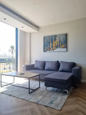 a living room with a couch and a coffee table at On Park by Smart City Stays in Cape Town