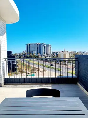 a bench on a balcony with a view of a city at On Park by Smart City Stays in Cape Town