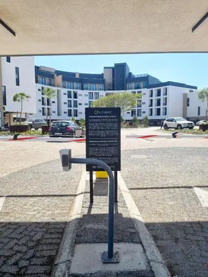 a sign on the side of a street with a parking lot at On Park by Smart City Stays in Cape Town
