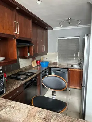 a kitchen with a counter and a chair in it at YA Eagle Wings Self Catering Shared Single room Lodge B in Cape Town