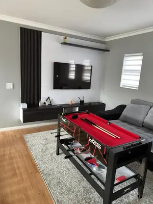 a living room with a pool table in front of a couch at YA Eagle Wings Self Catering Shared Single Room Lodge A in Cape Town