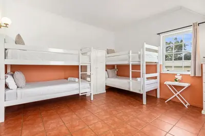 a room with two bunk beds and a window at Farmhouse in Cape Town