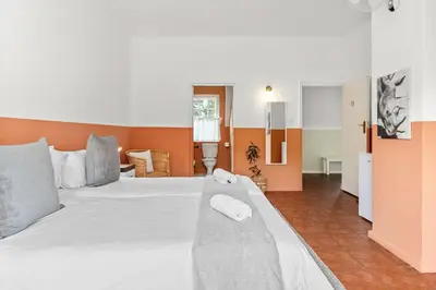 a bedroom with a white bed with a towel on it at Farmhouse in Cape Town