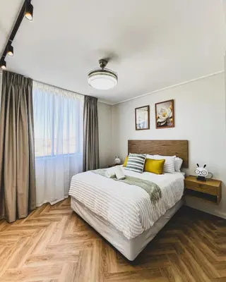 a bedroom with a large bed and a large window at Peace On Park by Dajosha booking in Cape Town
