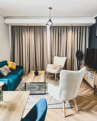 a living room with a couch and chairs and a tv at Peace On Park by Dajosha booking in Cape Town