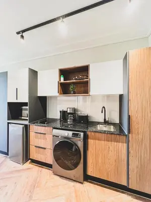 a kitchen with a washing machine and a sink at Love on Park by Dajosha bookings in Cape Town