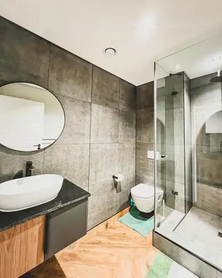 a bathroom with a sink and a toilet and a mirror at Love on Park by Dajosha bookings in Cape Town