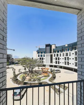 a balcony with a view of a park and buildings at Love on Park by Dajosha bookings in Cape Town