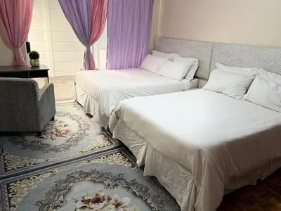 a bedroom with two beds and a couch at Miches House in Cape Town