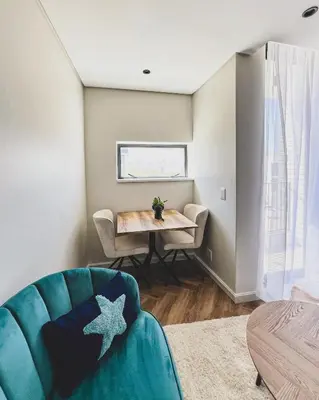 a living room with a blue couch and a table at Joy On Park by Dajosha Bookings in Cape Town