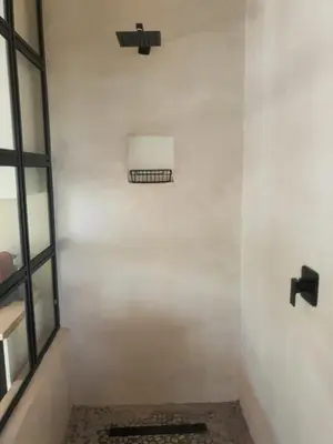 a room with a white wall with a window at Casa La Mer Guesthouse in Strand