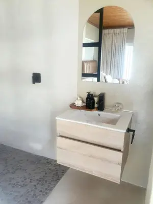 a bathroom with a white sink and a mirror at Casa La Mer Guesthouse in Strand