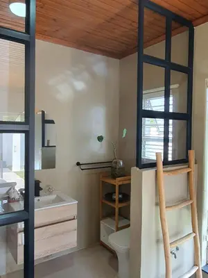 a bathroom with a sink and a toilet and a mirror at Casa La Mer Guesthouse in Strand
