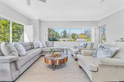 a living room with a couch and a table at Self-Catering Winelands Views Apartment Stellenbosch in Stellenbosch