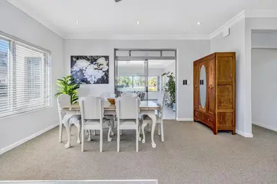 a dining room with a table and white chairs at Self-Catering Winelands Views Apartment Stellenbosch in Stellenbosch