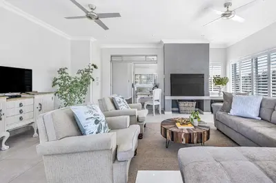 a living room with two couches and a table at Self-Catering Winelands Views Apartment Stellenbosch in Stellenbosch