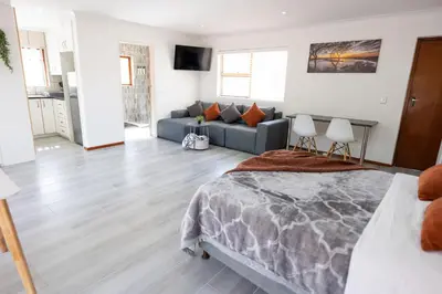 a bedroom with a bed and a couch at Mystical Serenity in Durbanville