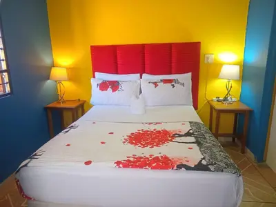 a bedroom with a large bed with a red headboard at Neo & Ruks rooms parow 2 in Avondale