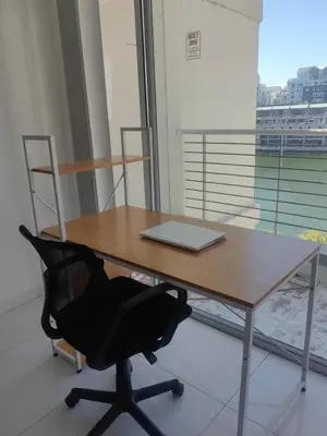 a wooden desk with a laptop on a chair at Water front apartment-Ocean Palace in Tyger Valley
