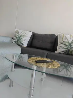 a living room with a couch and a glass table at Water front apartment-Ocean Palace in Tyger Valley