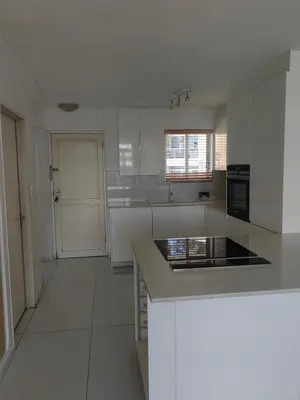a kitchen with white cabinets and a counter top at Water front apartment-Ocean Palace in Tyger Valley