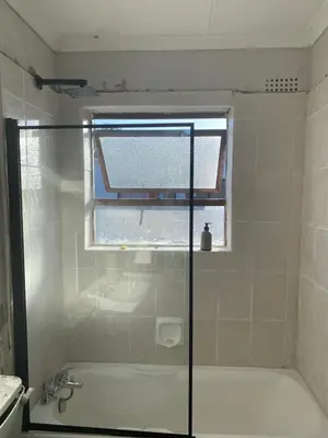 a bathroom with a bath tub and a window at The eden in Faure