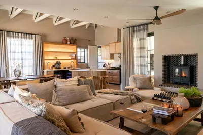 a living room with a couch and a table at Pink Door Franschhoek by The Oyster Collection in Franschhoek
