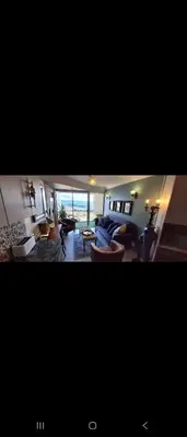 a living room with a couch and a table at 210 at Beach in Strand