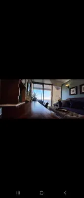 a view of a living room with a bed and a window at 210 at Beach in Strand