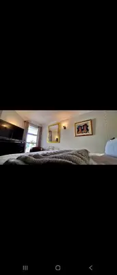 a bedroom with a bed and a window at 210 at Beach in Strand
