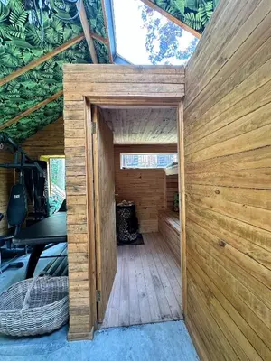 a wooden door to a sauna in a house at Green Cottage, Elgin Grabouw in Grabouw