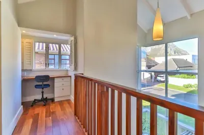 a home office with a desk and a balcony at Somer Sout in Voelklip, Hermanus in Hermanus